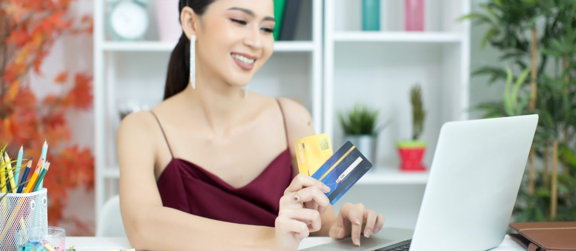 Young asian woman paying with credit card